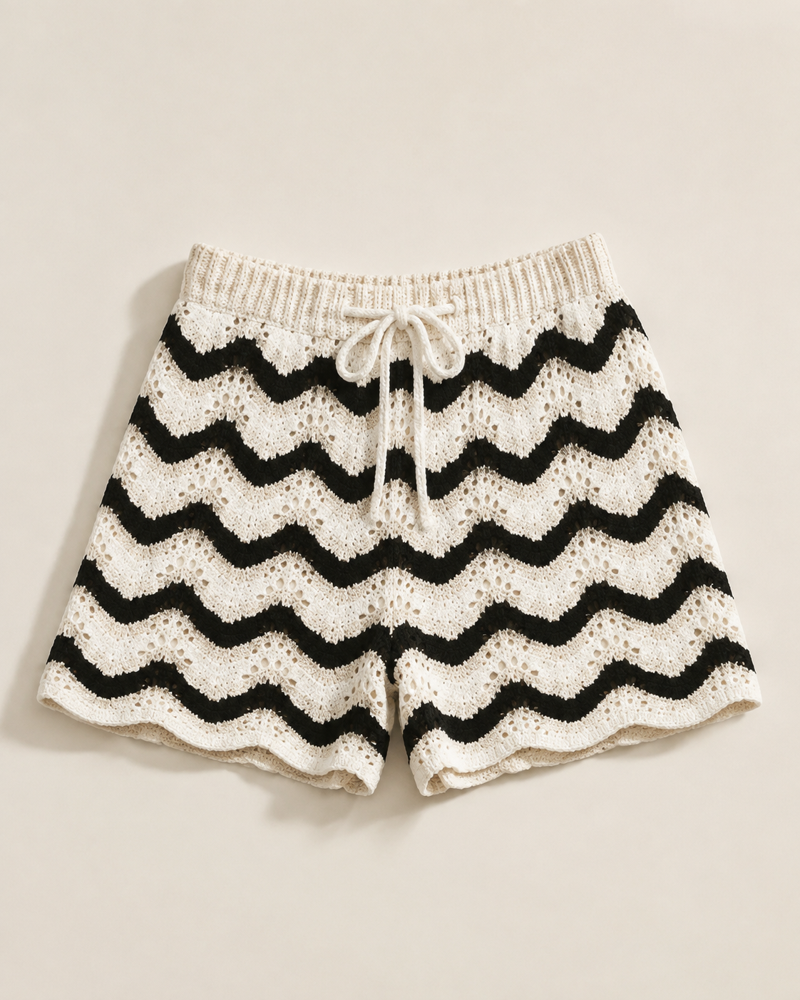 Black and white chevron knit shorts, studio view, full garment shown