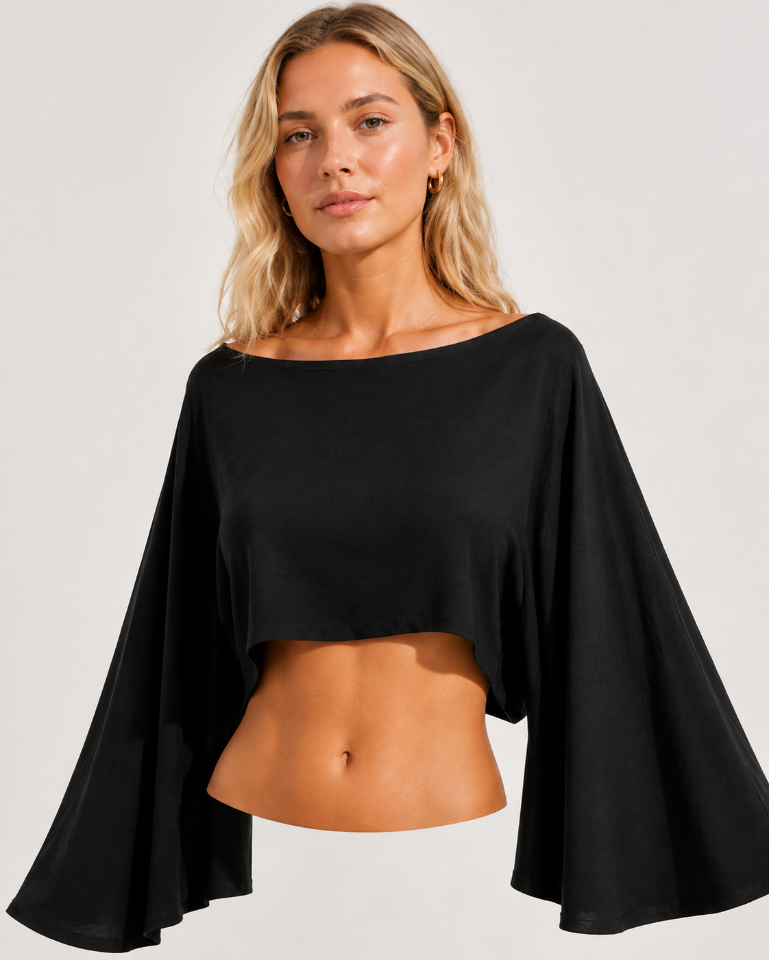Black cropped top detail showing the broad neckline and wide bell sleeves.