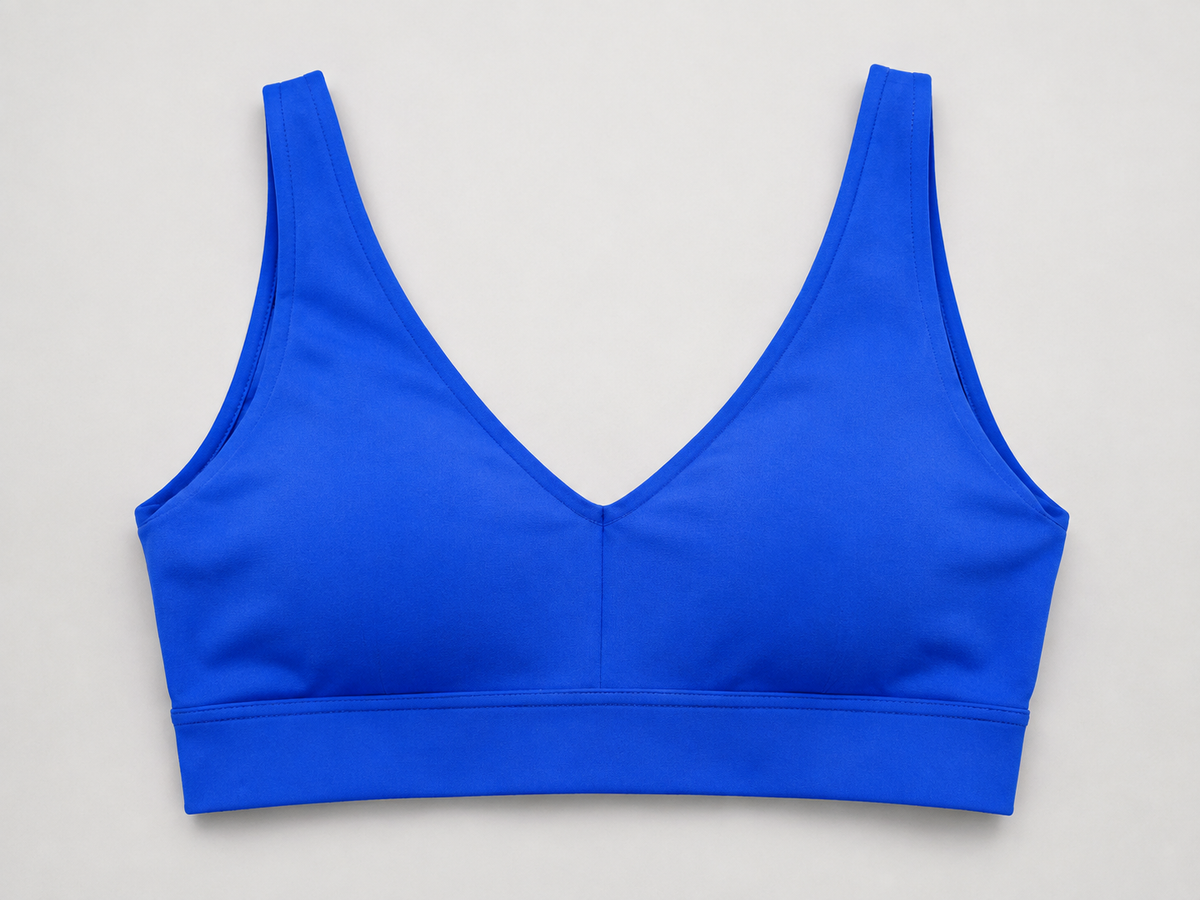 Blue sports bra detail showing the V-shaped neckline and wide underband.