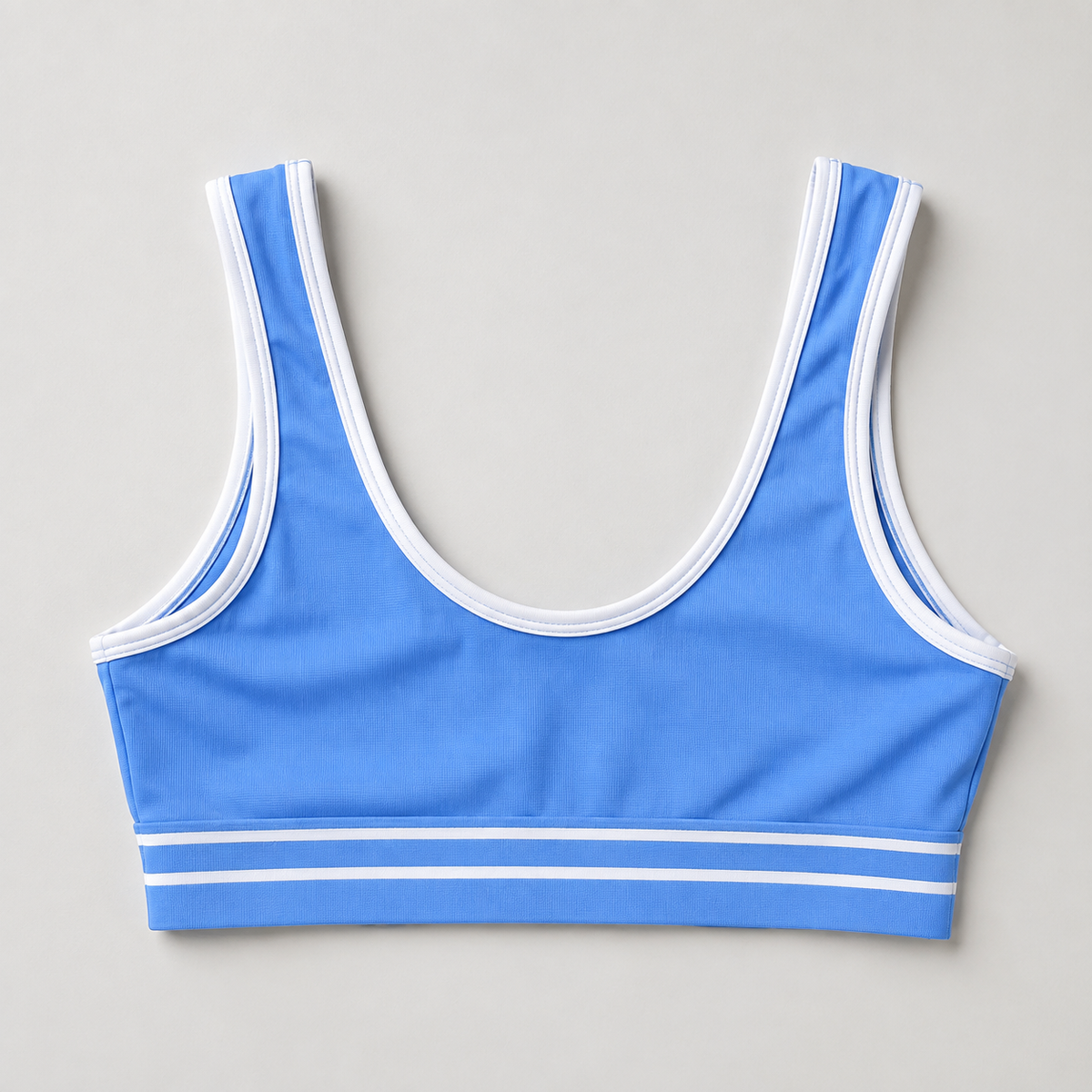 Blue sports bra back detail showing a scoop back and white contrast trim.