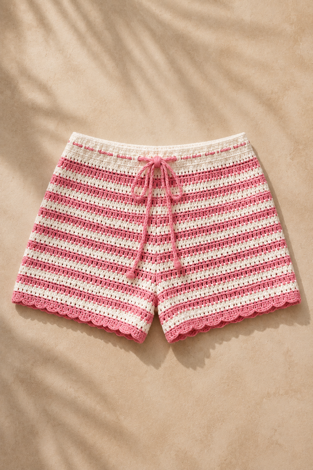 Pink crochet shorts, studio view, single garment shown