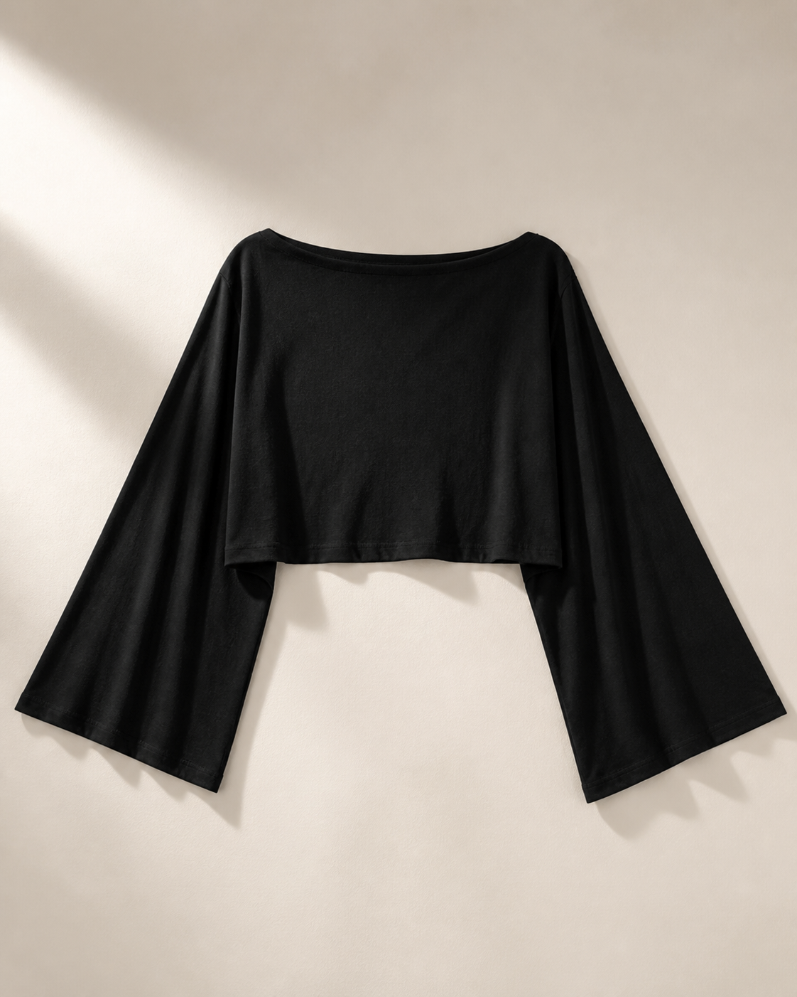 Black boat-neck crop top with wide draped sleeves, studio view