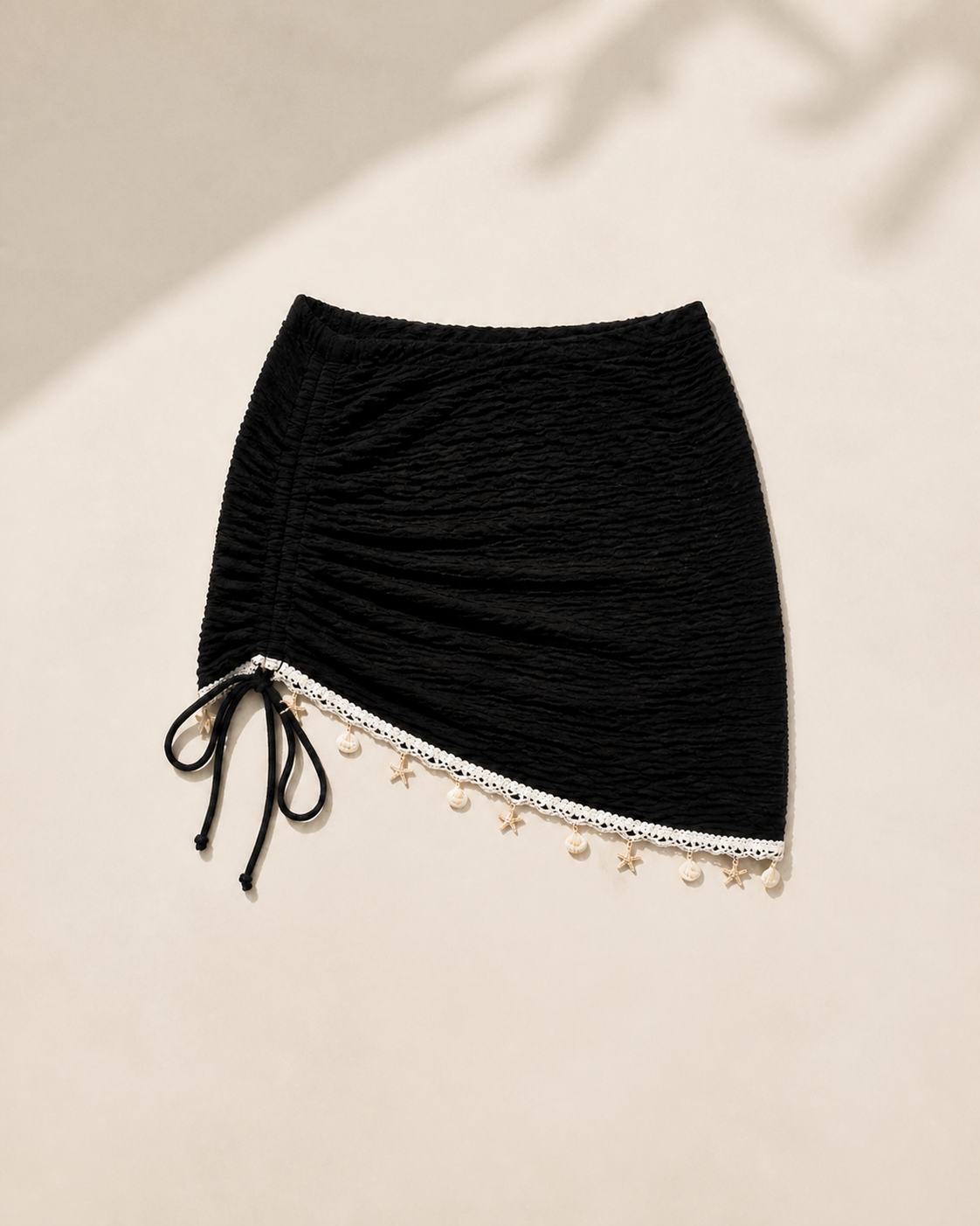 Black mini beach skirt, flat lay, full garment shown