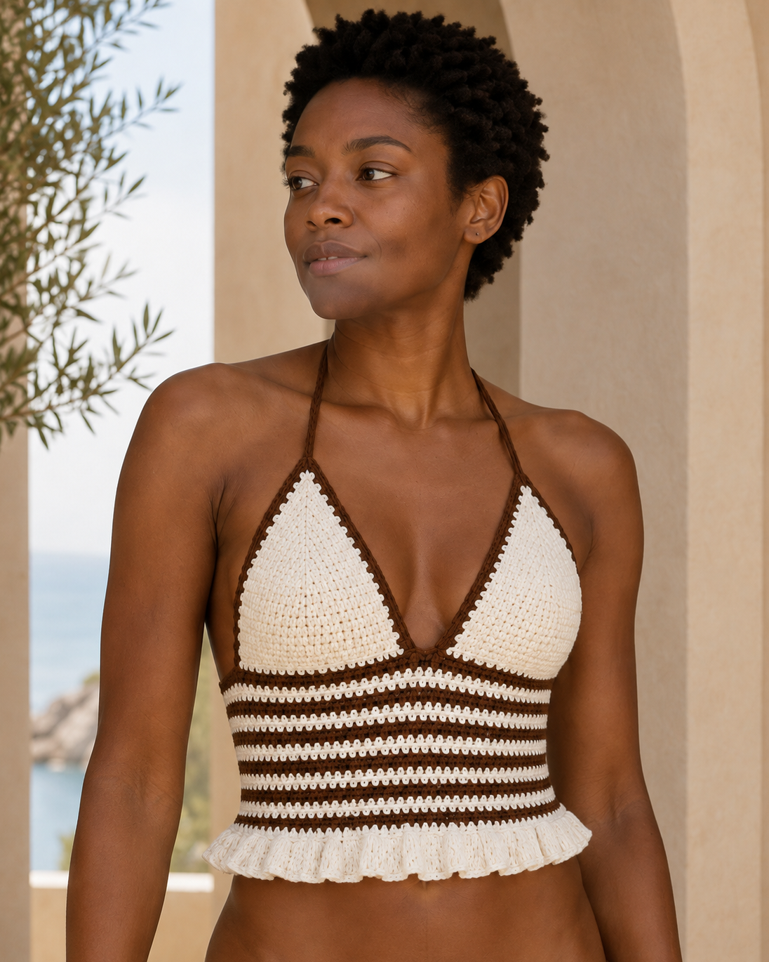 Brown and white striped crochet halter top, product-focused model view