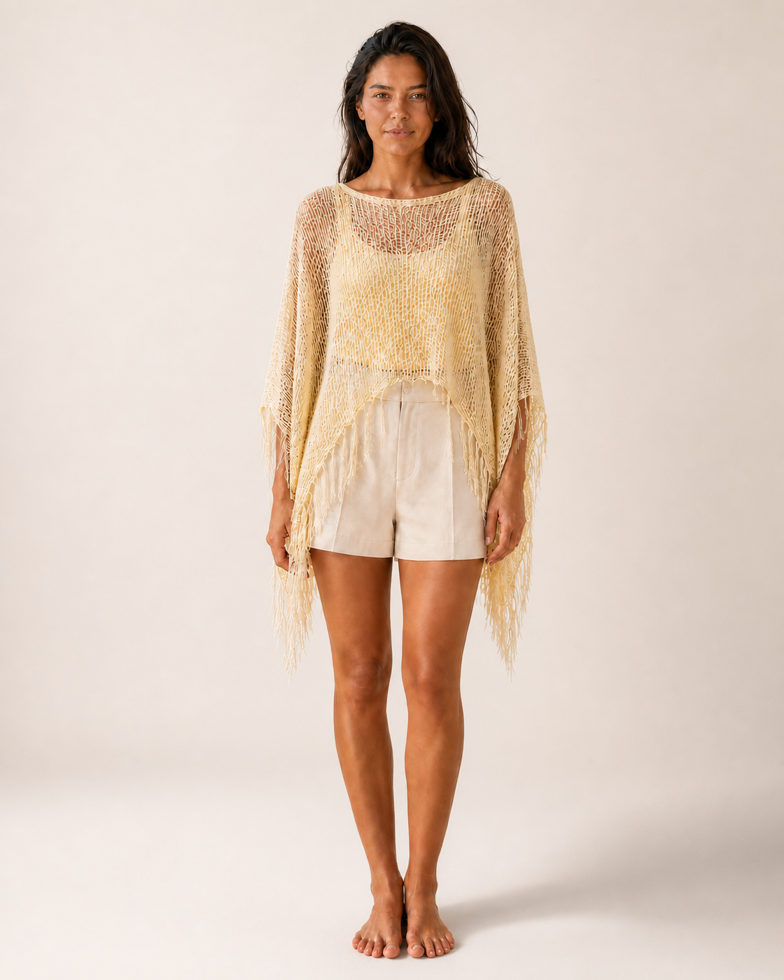 Pale Yellow Sheer Mesh Fringe Poncho Cover-Up on medium warm-tan model, front view