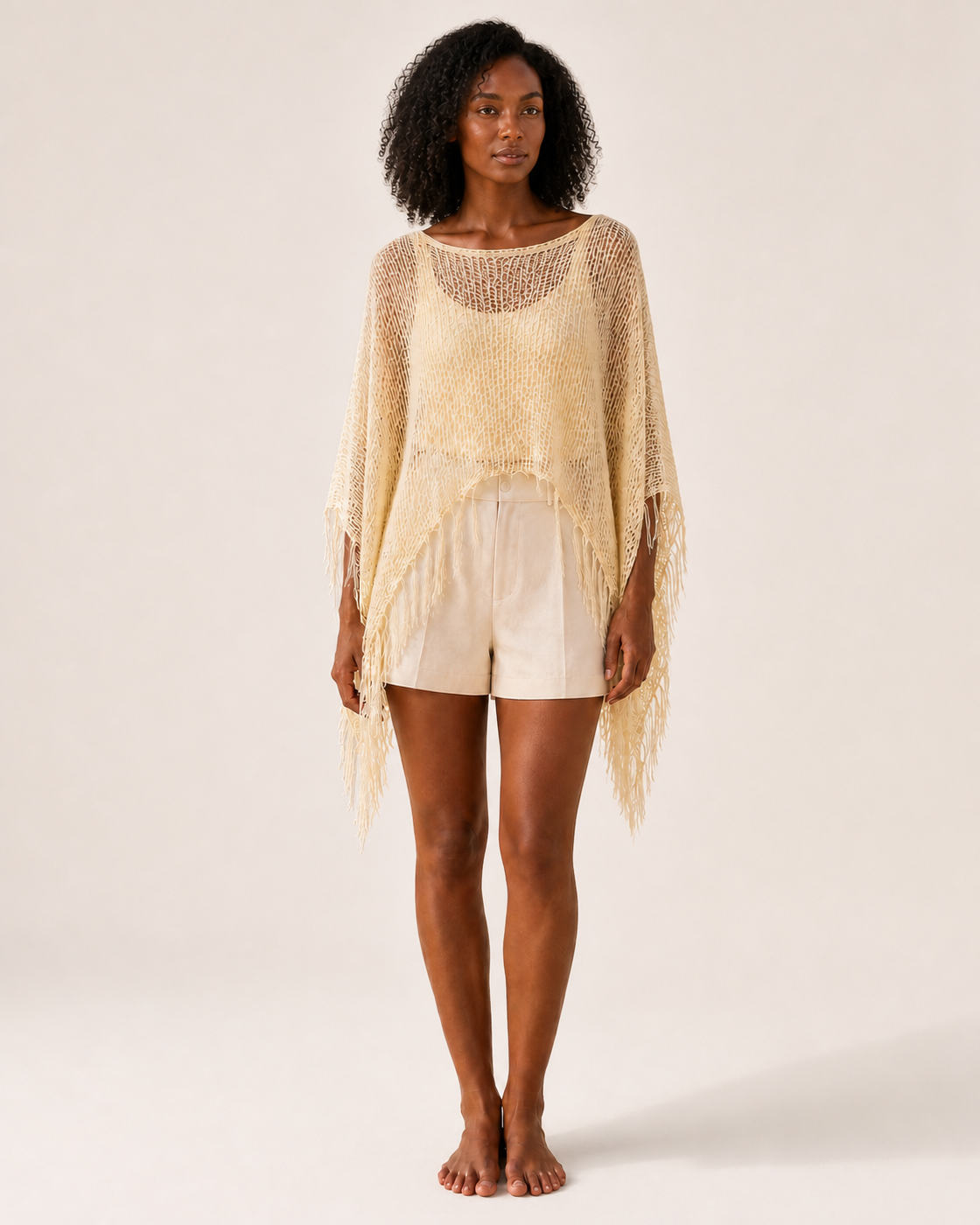 Pale Yellow Sheer Mesh Fringe Poncho Cover-Up on medium-deep brown model, front view