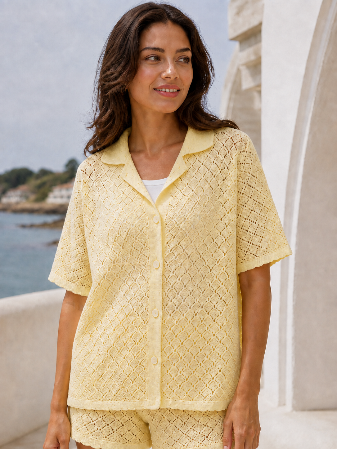 Latina model wearing the pale yellow pointelle shirt over a white tank, product-focused view