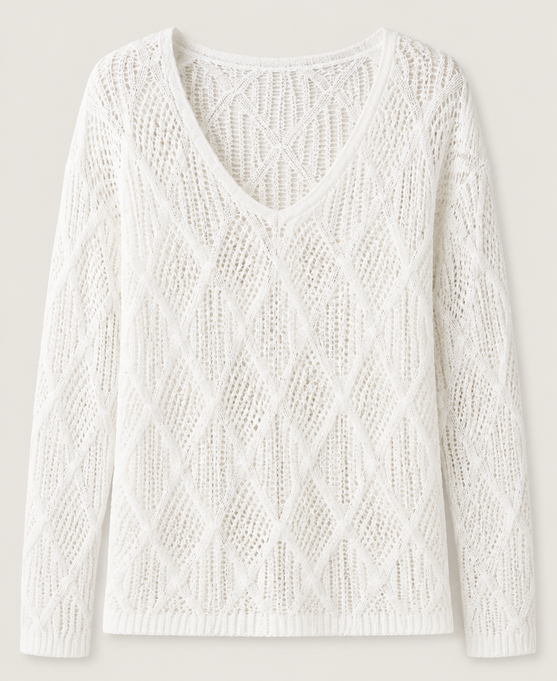 White knit V-neck tunic detail showing the open diamond pattern and long sleeves.