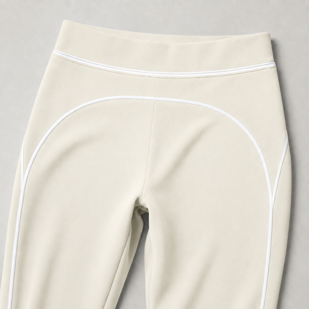 Ivory leggings high waistband and curved white piping detail.