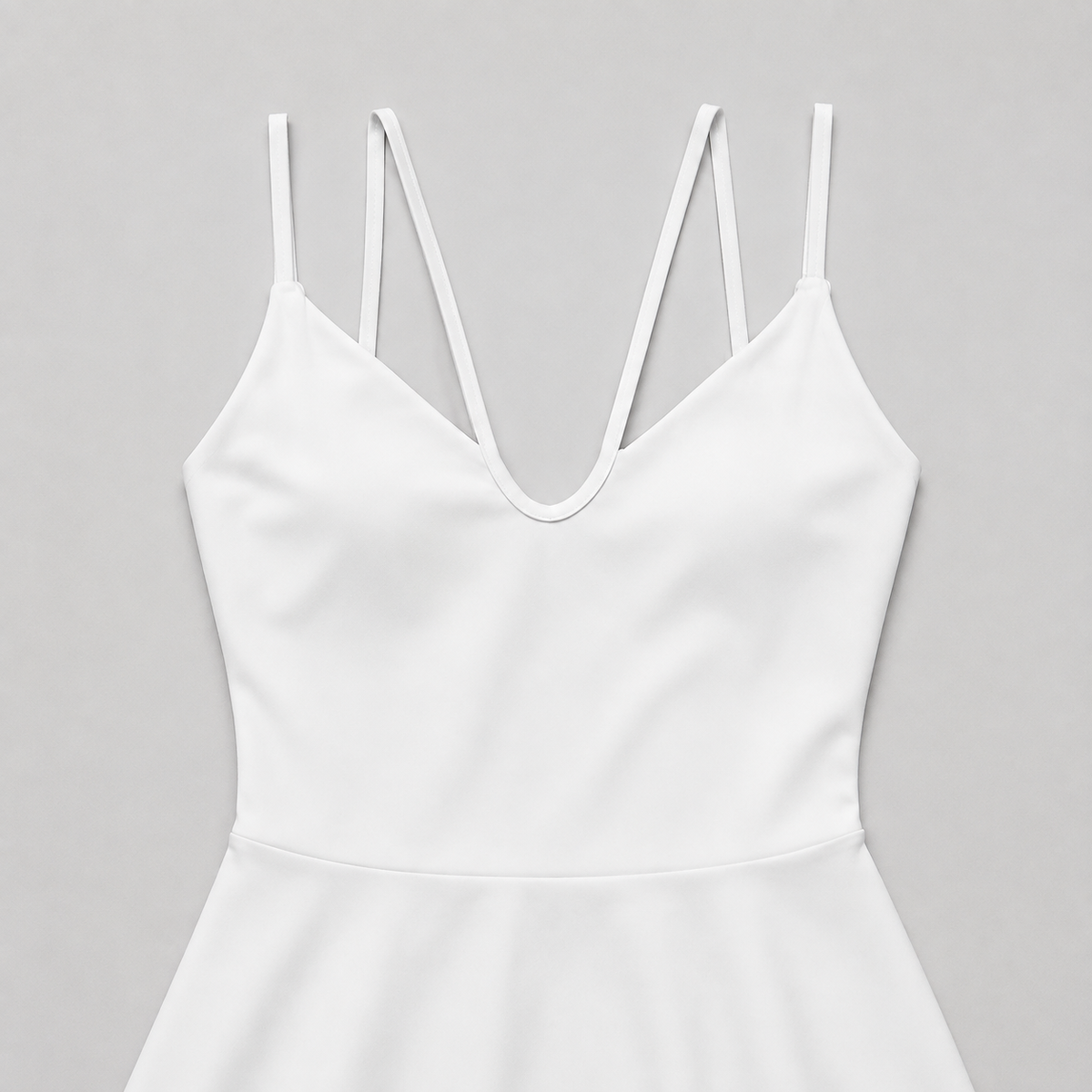 White tennis mini dress neckline detail showing the four slender front strap segments.