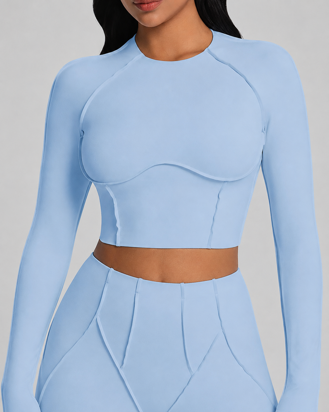 Powder-blue crop top detail showing curved front seams and the clean waist break.