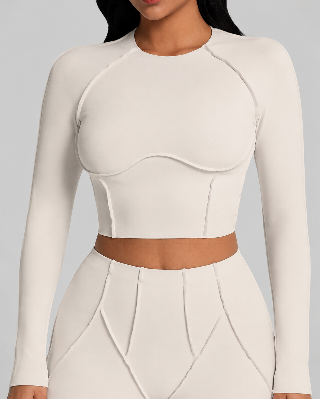 Ivory crop top detail showing curved front seams and the clean waist break.