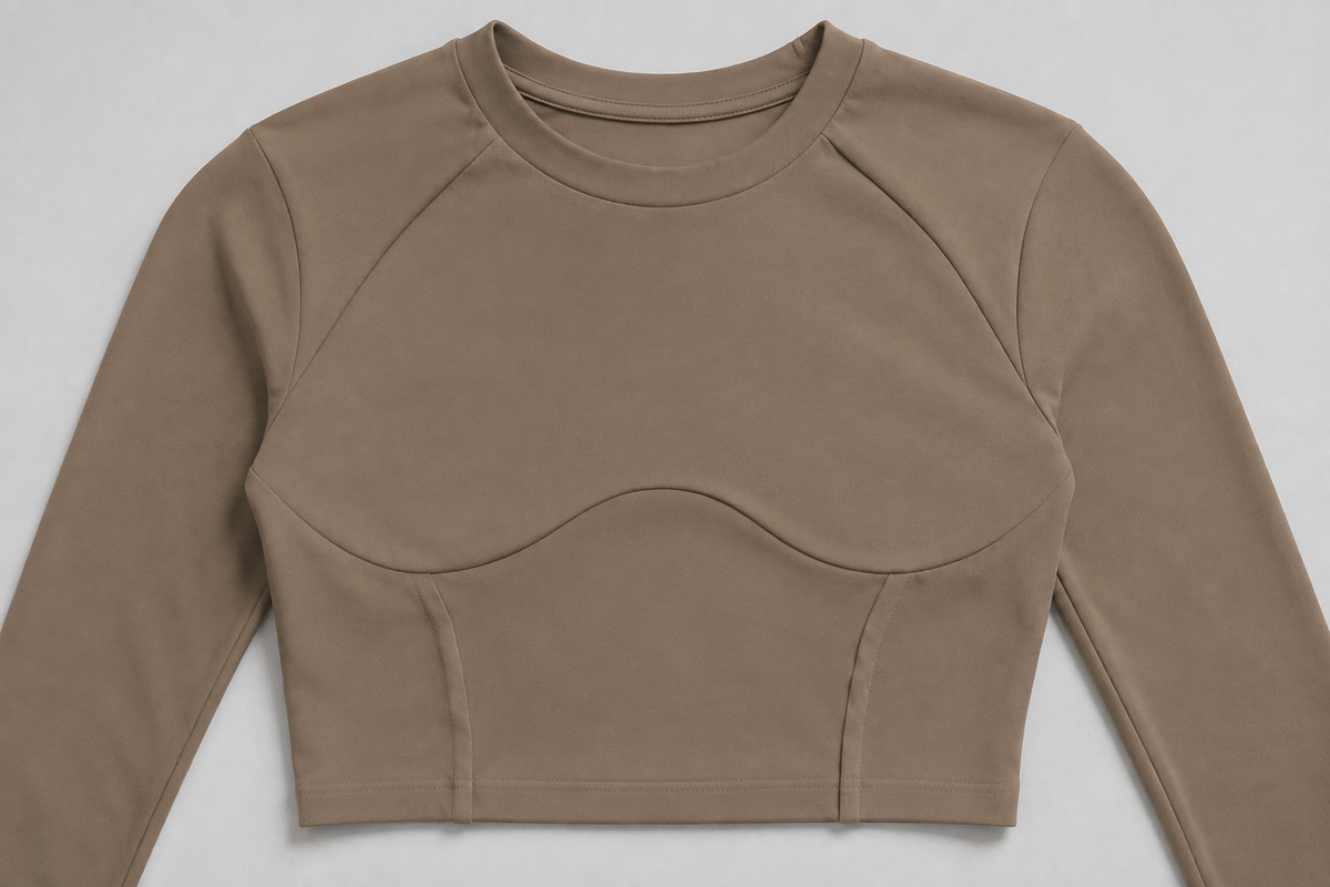 Taupe crop top detail showing the curved front seams and cropped hem.