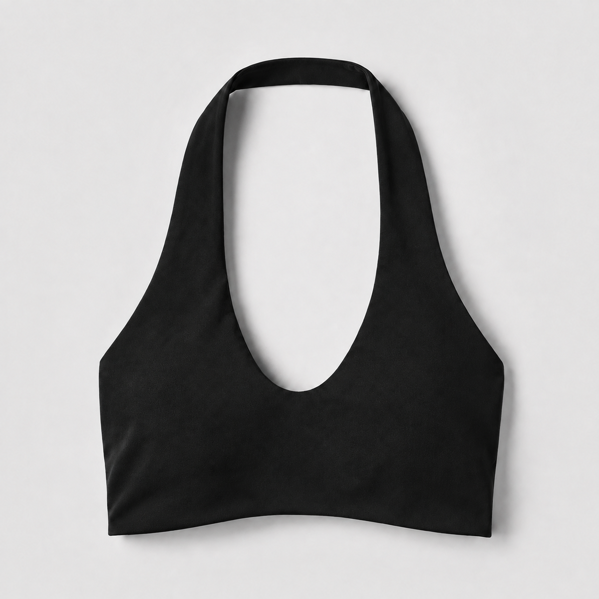 Black halter sports bra front with a deep rounded neckline and broad halter straps.