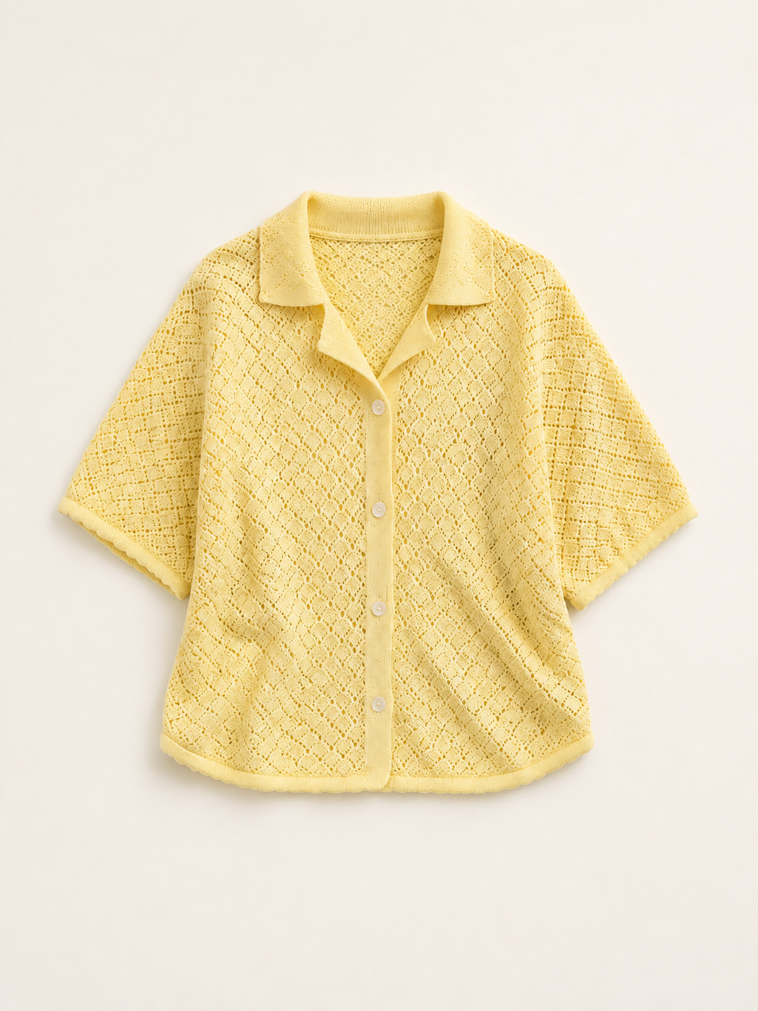 Pale yellow pointelle knit shirt, studio view, full garment shown
