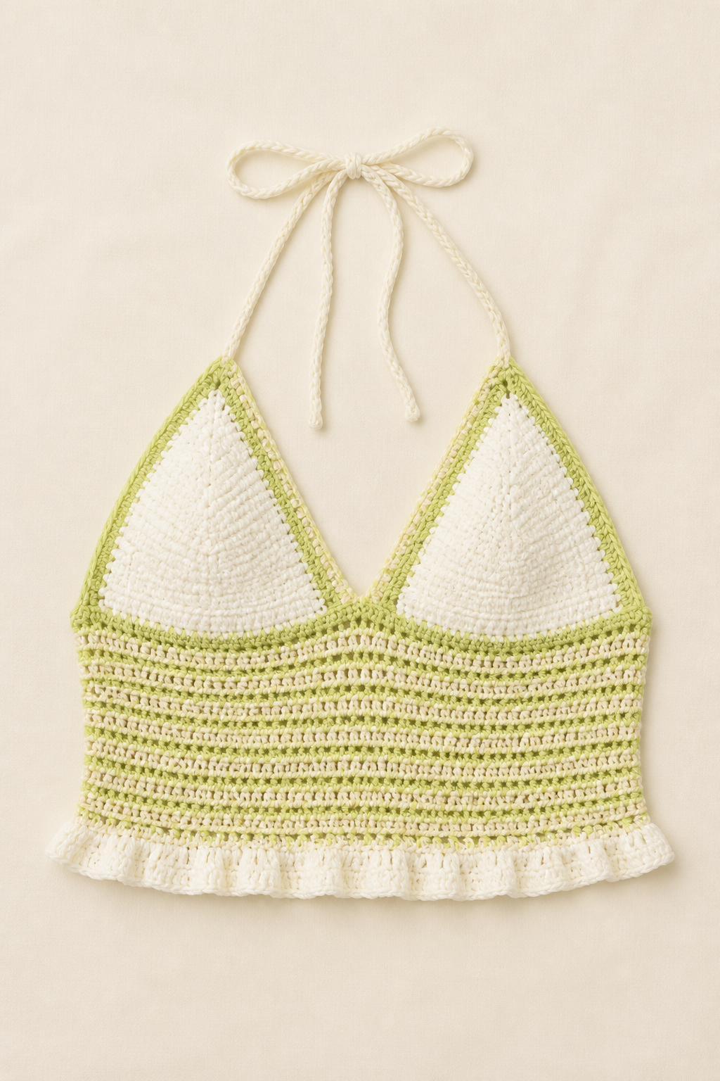 Pale lime green and ivory striped crochet halter top shown alone in a studio flat lay