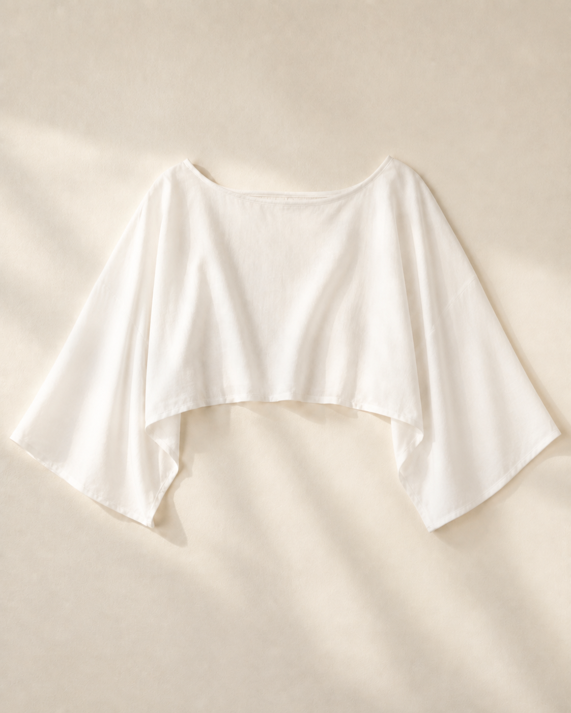 White batwing crop top, studio view, full garment shown
